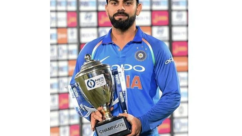 Virat Kohli Indian captain Virat Kohli holds the winner's trophy after beating New Zealand in the 3rd ODI at Kanpur. Photo: PTI