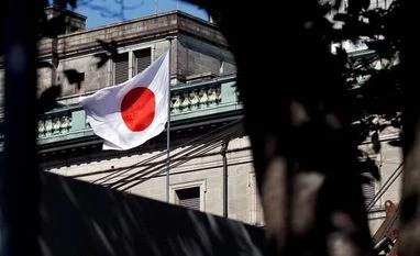 Bank of Japan A Japanese flag flutters atop the Bank of Japan building under construction in Tokyo. Photo: Reuters