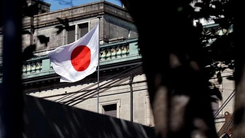 Bank of Japan A Japanese flag flutters atop the Bank of Japan building under construction in Tokyo. Photo: Reuters