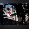 Bank of Japan A Japanese flag flutters atop the Bank of Japan building under construction in Tokyo. Photo: Reuters