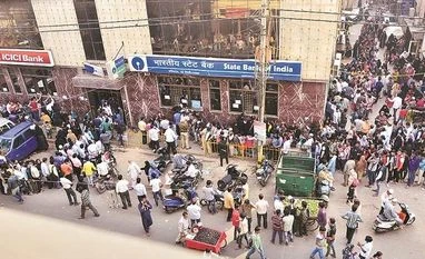 Demonetisation killed people in ATM queues, put India in doldrums: Manmohan File photo of people queuing up outside ATMs after the demonetisation drive