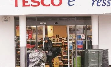 UK supermarket giant Tesco sees profit dented by Covid related costs Tesco