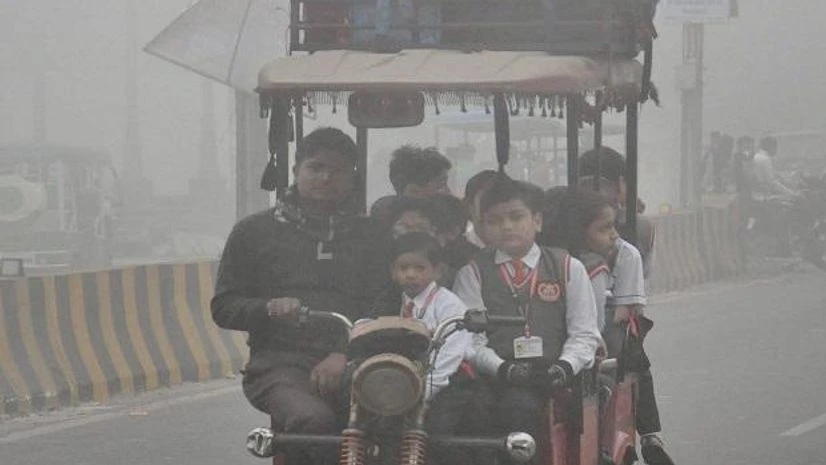 DELHI WINTER Students, clad in winter uniforms, on their way to school