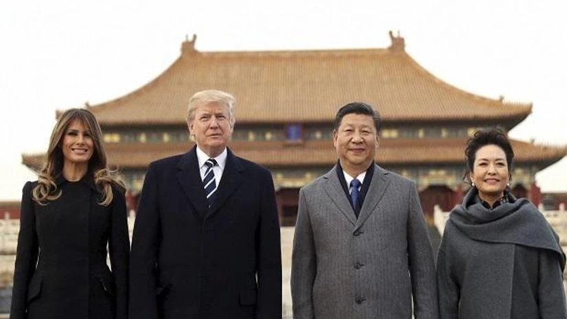 President Donald Trump, second left, first lady Melania Trump, left, Chinese President Xi Jinping, second right, and his wife Peng Liyuan, right, stand together as they tour the Forbidden City. Photo: AP/PTI President Donald Trump, second left, first lady Melania Trump, left, Chinese President Xi Jinping, second right, and his wife Peng Liyuan, right, stand together as they tour the Forbidden City. Photo: AP/PTI