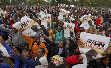 Zimbabwe coup: The house of Mugabe crumbles, but it's too soon to celebrate Protesters hold posters asking President Mugabe to step down at a demonstration at Zimbabwe Grounds in Harare, Zimbabwe. (Photo: PTI)