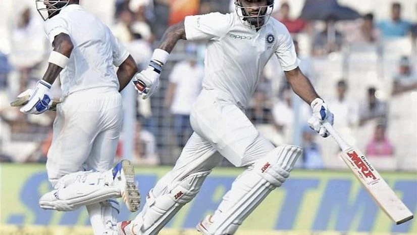 Shikhar Dhawan and KL Rahul India's Shikhar Dhawan and KL Rahul cross for a run during Day 4 of the first cricket test math against Sri Lanka at Eden Gardens in Kolkata on Sunday