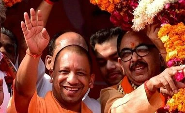 Buoyed by civic poll sweep, Adityanath to roll out 12 new policies in Dec UP Chief Minister Yogi Adityanath and State BJP chief Mahendra Nath Pandey being garlanded during a party rally in Aligarh. (File photo: PTI)