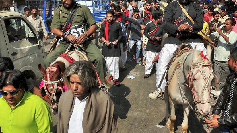Congress workers, dressed up as characters of film Sholay, take out a protest rally against GST in Surat Congress, Sholay