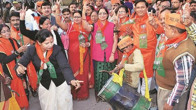 UP Civic Polls BJP activists celebrate in Varanasi on Friday, after Mridula Jaiswal won the Mayor’s post in the civic election. Photo: PTI