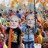 Supporters wear mask of Prime Minister Narendra Modi during an election campaign rally in support of BJP candidates, in Gujarat