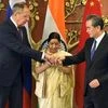 New Delhi: Union Minister for External Affairs Sushma Swaraj with her Chinese counterpart  Wang Yi and Russian Foreign Minister Sergey Lavrov join hands before the Russia-India-China Foreign Ministerial Meeting at Jawahar Lal Nehru Bhawan in New Delh