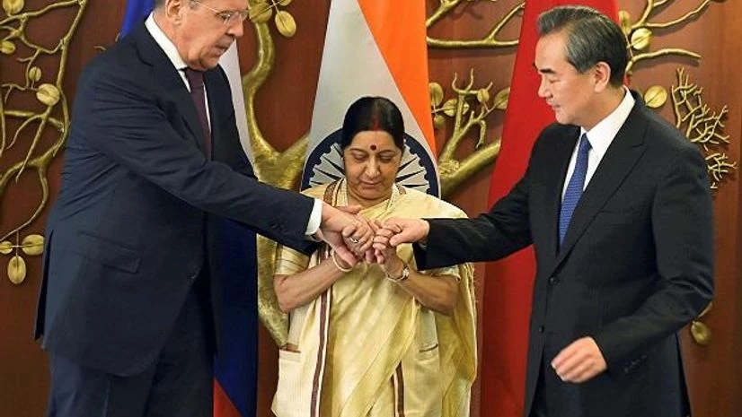 New Delhi: Union Minister for External Affairs Sushma Swaraj with her Chinese counterpart Wang Yi and Russian Foreign Minister Sergey Lavrov join hands before the Russia-India-China Foreign Ministerial Meeting at Jawahar Lal Nehru Bhawan in New Delh New Delhi: Union Minister for External Affairs Sushma Swaraj with her Chinese counterpart Wang Yi and Russian Foreign Minister Sergey Lavrov join hands before the Russia-India-China Foreign Ministerial Meeting at Jawahar Lal Nehru Bhawan in New Delh