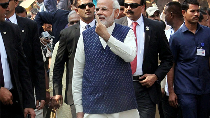 Prime Minister Narendra Modi shows his finger marked with indelible ink, as he leaves after casting his vote Prime Minister Narendra Modi shows his finger marked with indelible ink, as he leaves after casting his vote