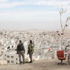 Israeli border police officers overlooking the Arab neighborhood of Issawiyah in Jerusalem