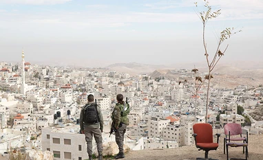 Israel targets Hamas military posts in Gaza after Palestinian bomb attack Israeli border police officers overlooking the Arab neighborhood of Issawiyah in Jerusalem