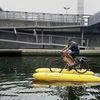 Assam man pedals floating cycle made from bamboo to clear Thames of plastic