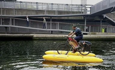 Assam man pedals floating cycle made from bamboo to clear Thames of plastic Assamese, Thames, floating cycle