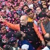 BJP President Amit Shah flashes victory sign as he is welcomed on his arrival at the party headquarters in New Delhi on Monday, after the party's victory in the Assembly elections in Gujarat and Himachal Pradesh