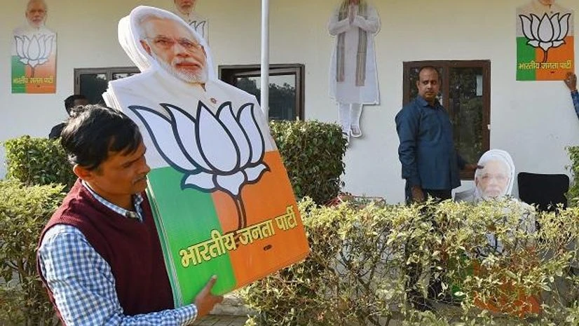 A worker carries cut-outs at the BJP headquarters in New Delhi on Monday, for the celebrations after the party's victory in the Assembly elections in Gujarat and Himachal Pradesh. Photo: PTI A worker carries cut-outs at the BJP headquarters in New Delhi on Monday, for the celebrations after the party's victory in the Assembly elections in Gujarat and Himachal Pradesh. Photo: PTI