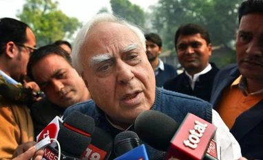 Congress' LS whip asks why Kapil Sibal is speaking language of RSS,BJP Congress leader Kapil Sibal addresses the media on 2G outside the Parliament House in New Delhi