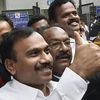 Former Telecom minister A Raja waves at his supporters after he was acquitted by a special court in the 2G scam case, in New Delhi