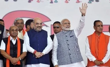 After call with Amit Shah, Nitin Patel agrees to take charge of ministries Prime Minister Narendra Modi, BJP President Amit Shah along with new CM Vijay Rupani and other state ministers during the swearing-in ceremony at Gandhinagar, Ahmedabad in Gujarat | File PTI Photo