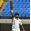 Vidarbha batsman Akshay Wadkar celebrates his half century during the 3rd day of the Ranji Trophy final cricket match against Delhi, in Indore. Photo: PTI