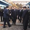 Paju: In this photo provided by South Korea Unification Ministry, the head of North Korean delegation Jon Jong Su, center, is greeted by a South Korean official as he crosses a border line to attend their meeting at Panmunjom in the Demilitarized Zon
