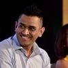 Chennai Super Kings (CSK) skipper MS Dhoni flanked by India Cements Director Rupa Gurunath reacts during an event