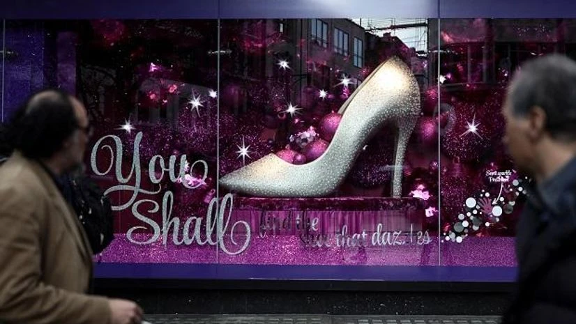 Christmas shoppers look at a shop window in Oxford Street Christmas shoppers look at a shop window in Oxford Street