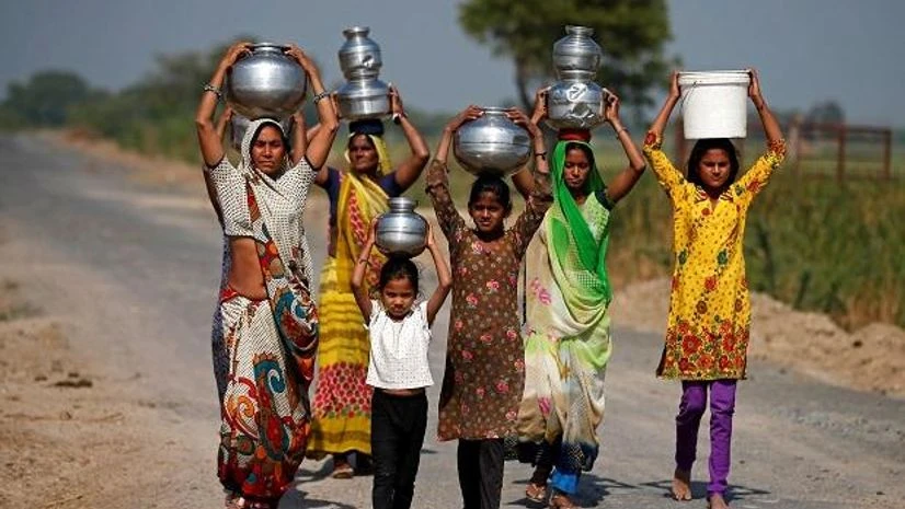 Village women and girls carry water at Fangadi Village on the outskirts of Ahmedabad. Photo: Reuters. Village women and girls carry water at Fangadi Village on the outskirts of Ahmedabad. Photo: Reuters.