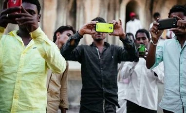 India's smartphone users likely to reach 650 million by 2022, says EY People using smartphone as camera