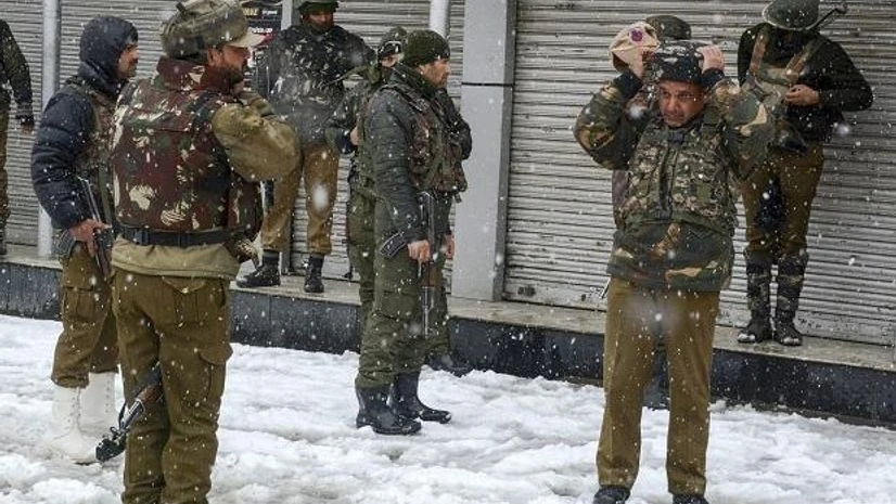 Kashmir, Snowfall in Kashmir Special Operation Group (SOG) of Jammu and Kashmir Police personnel take positions near the building where militants were sheltering during an encounter, near a CRPF camp at Karra Nagar in Srinagar. (PTI Photo)