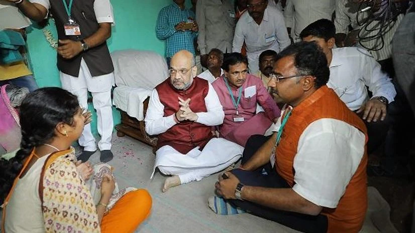 Amit Shah BJP National President Amit Shah visits the home of Late Shivaraj Basalingappa Alreddy, a farmer who committed suicide at Mangalgi Village. Photo: PTI