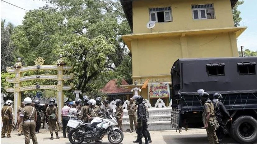Sri Lanka Violence, Kandy violence Sri Lankan police officers stand out side a vandalized Buddhist Temple in Poojapitiya, in central Sri Lanka. (Photo:
