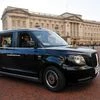 Neville Robertson, a London cabbie, drives the new TX City London taxi past Buckingham Palace
