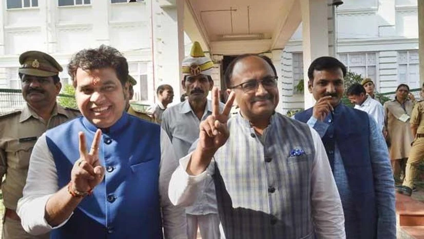 Leader of Opposition Ram Govind Chaudhary (centre) flashes a victory sign as he leaves the Tilak Hall after casting vote for Rajya Sabha in Lucknow Leader of Opposition Ram Govind Chaudhary (centre) flashes a victory sign as he leaves the Tilak Hall after casting vote for Rajya Sabha in Lucknow