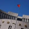 A Chinese national flag flutters outside the headquarters of the People's Bank of China, the Chinese central bank, in Beijing. (Photo: Reuters)