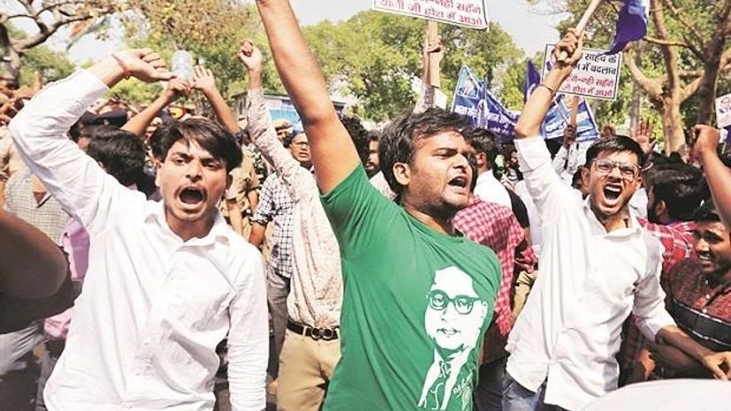 How a Brahmin vs Dalit vs Patidar office fight set streets of India on fire Delhi: People belonging to the Dalit community shout slogans as they take part in the strike