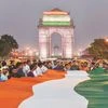 People hold a 200-ft-long Tricolour while taking part in a 'Tiranga March' to protest alleged communalisation of Kathua rape case, at India Gate in New Delhi on Saturday. 	Photo: PTI