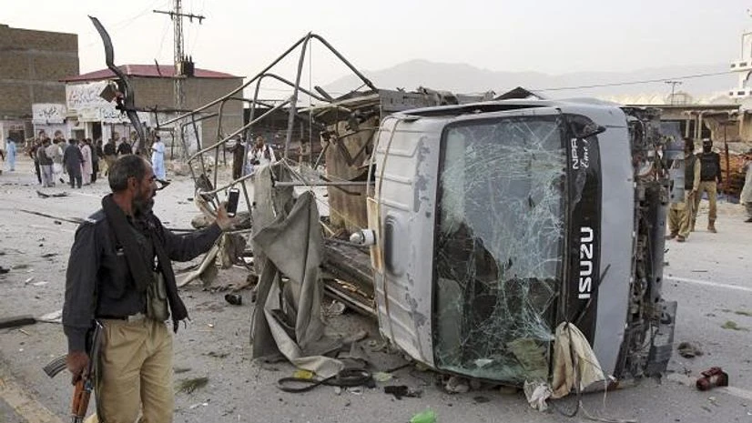 pakistan suicide attack A Pakistani police officer walks past a police vehicle targeted by a suicide bomber in Quetta, Pakistan, Tuesday, April 24, 2018