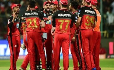 IPL 2018: Bowlers turn it around for RCB, Mumbai Indians lose by 14 runs Royal Challengers Bangalore's Virat Kohli celebrates with teammates the wicket of Mumbai Indians' Rohit Sharma during the IPL 2018 cricket match at Chinnaswamy Stadium in Bengaluru. Photo: PTI