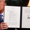 US President Donald Trump holds up a proclamation declaring his intention to withdraw from the JCPOA Iran nuclear agreement after signing it in the Diplomatic Room at the White House in Washington, US | File Photo: Reuters