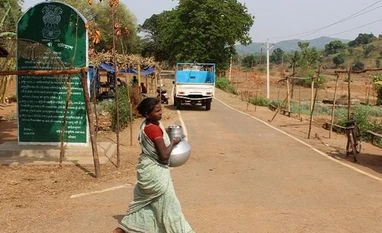 Helping poor people top priority of Jharkhand govt policies: Governor A woman passes the stone erected at the village crossing. | Photo: Ankur Paliwal