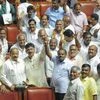 JD(S) leader HD Kumaraswamy and party MLAs show victory sign to celebrate after chief minister BS Yediyurappa announced his resignation before the floor test, at Vidhana Soudha, in Bengaluru, on Saturday
