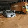 Mangaluru: Vehicles ply on a waterlogged road after heavy rains on Tuesday. Photo: PTI