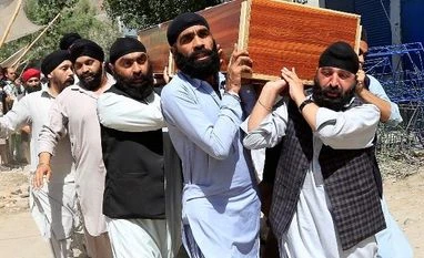 IS claims Afghanistan attack on Sikhs, Hindus, says targeted 'polytheists' Afghan Sikh men carry the coffin of one of the victims of the blast in Jalalabad city, Afghanistan. Photo: Reuters
