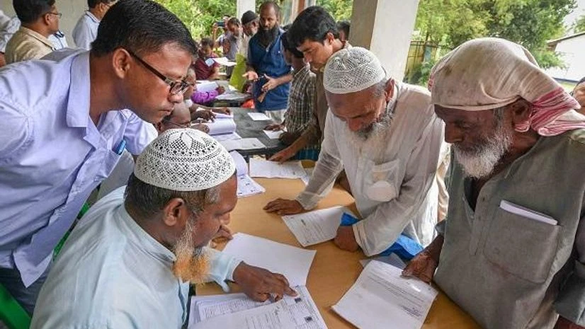 assam nrc, nrc People check their names on the final draft of the state's National Register of Citizens after it was released, at a NRC Seva Kendra in Nagaon on Monday