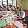 People check their names on the draft list at the National Register of Citizens centre at a village in Nagaon district