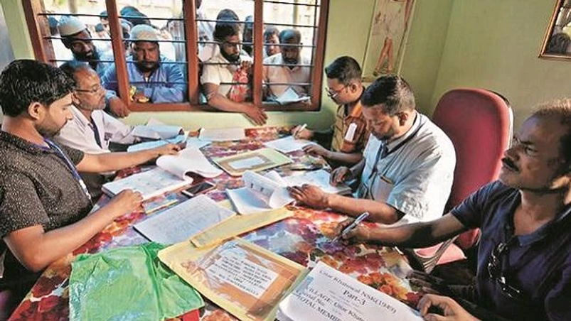 nrc, assam, illegal immigrants People check their names on the draft list at the National Register of Citizens centre at a village in Nagaon district